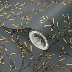 a grey and gold wallpaper with yellow leaves on the top right hand corner is an olive branch design