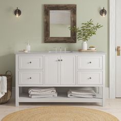 a bathroom with a rug, sink and mirror