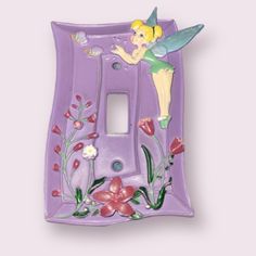 a purple light switch cover with a tinkerbell fairy on it's side