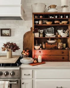 a kitchen with white cabinets and an old fashioned stove