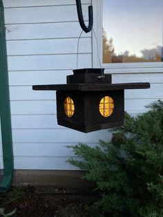 a light hanging from the side of a house