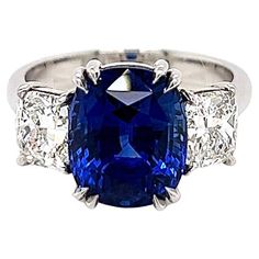 7.87 Total Carat Sapphire and Diamond Ladies Ring. GIA Certified. -Metal Type: Platinum -6.27 Carat Cushion Cut Natural Blue Sapphire, GIA Certified -Sapphire Measurements: 10.62 x 8.77 x 7.45 mm -0.80 Carat Cushion Cut Natural side Diamond. GIA Certified (Report: 2155461561). H Color, VS1 Clarity -0.80 Carat Cushion Cut Natural side Diamond. GIA Certified (Report: 2155461646). H Color, VS2 Clarity -Size 6.5 Made in New York City. Luxury Blue Sapphire Ring As Gift, Luxury Gia Certified Sapphire Jewelry, Luxury Fine Jewelry Sapphire Ring As Gift, Cocktail Ring Designs, Ring Cushion, Cushion Ring, Ladies Ring, Sapphire Diamond Ring, Natural Blue Sapphire