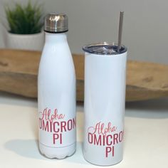 two white insulated water bottles sitting next to each other on top of a table