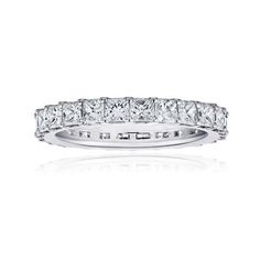 a white gold ring with princess cut diamonds on the sides and four rows of baguetts