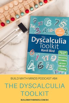 the dyscalculalia tool kit is next to a book and pencils