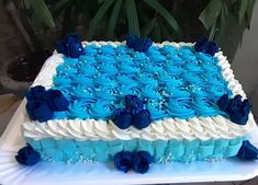 a large blue and white cake sitting on top of a table