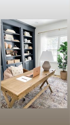 a living room filled with furniture and a laptop computer on top of a wooden table