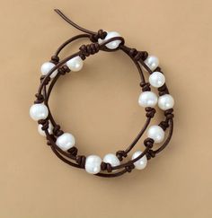 Freshwater Pearl Leather Bracelet Wrap yourself in the beauty of fall with this Freshwater Pearl Leather Bracelet. Crafted with genuine freshwater pearls and durable brown leather, this bracelet perfectly captures the essence of autumn. Each pearl is delicately hand-knotted, creating a natural, rustic feel. The minimalist yet elegant design makes it a versatile piece that pairs well with casual outfits or adds a touch of class to more formal looks. Features: Material: Genuine freshwater pearls a 1mm Leather Cord Bracelet, Casual Cheap Leather Bracelet, Cheap Handmade Leather Bracelet For Everyday, Cheap Adjustable Leather Strap Bracelets, Leather And Pearl Ring, Leather Bracelet Tutorial Handmade, Leather Bracelet Tutorial, Wrap Armband, Leather Cord Bracelets