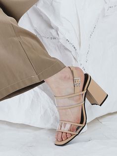 - Square open toe- Transparent PVC upper- Buckled slingback strap- Wrapped block heel with rubber cap- Padded footbed- Tonal stitchMeasurements(in.)- Heel: 3.1- Size: KR225(US5.5)-KR250(US8.0)Composition & Care- Cowhide + PVCDesigner- Imported- by AWESOME DEW- Style#:300638825 Modern Sandals With Clear Strap And Block Heel, Beige Open Toe Block Heels With Buckle Closure, Modern Sandals With Clear Strap And Open Heel, Spring Open Toe Slingback Pumps With Contrasting Heel, Formal Sandals With Clear Strap And Block Heel, Modern Beige Heels With Buckle Closure, Formal Open Toe Sandals With Clear Strap, Formal Heels With Clear Strap And Block Heel, Formal Block Heels With Clear Strap