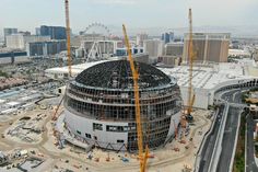 an aerial view of a large building under construction in las vegas, with the city skyline in the background