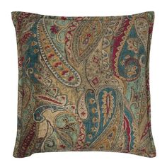 a decorative pillow with an intricate paisley pattern on the front and sides, in blue, red