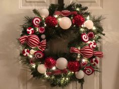 a christmas wreath with candy canes and ornaments