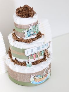 three tiered diaper cake sitting on top of a table