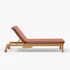 a wooden chaise lounge chair with an orange cushion on it's back and legs