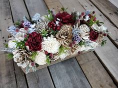 a wooden box filled with lots of flowers