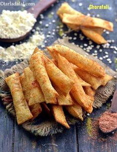 french fries on a plate with seasoning next to them