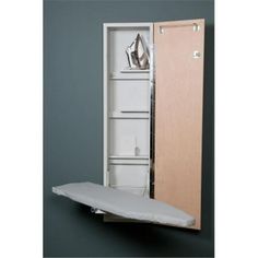 an ironing board is in front of a cabinet with its door open to show the contents