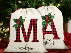 two personalized christmas stockings with holly on them