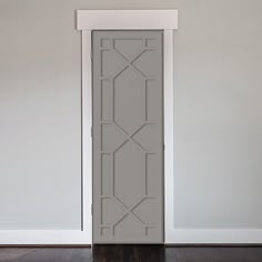 an empty room with a white door and wood flooring on the wooden floor next to it