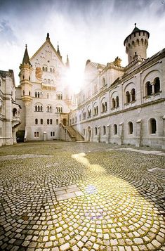 an old castle with cobblestones on the ground