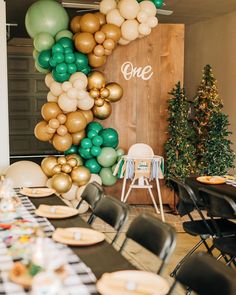 the table is set with balloons and plates