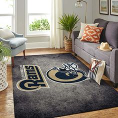 a living room with a couch, chair and rug that has the penn football team on it