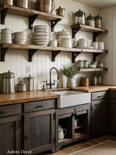 a kitchen filled with lots of pots and pans on shelves above a white sink