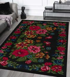 a black rug with flowers on it in a living room