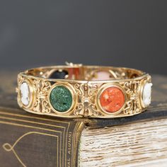 This piece of jewelry comes with it a deep sense of nostalgia! I adore the colors on the different cameos - such a sweet way to add color to one's wrist. But the bets part is the piece's original receipt, dated 1976 from Italy, and its original box. Beautiful an romantic workmanship as only the Italians can! Just beautiful on the wrist. 14kt yellow gold Will fit up to a 7.5" wrist. Please see qualitative report for more information. Antique Multi-stone Bracelet As Gift, Antique Multi-stone Bracelets As Gift, Multicolor Victorian Jewelry For Formal Occasions, Victorian Multicolor Formal Jewelry, Intaglio Bangle Jewelry As A Gift, Vintage Multi-stone Bracelets Gift, Victorian Multicolor Jewelry For Wedding, Intaglio Bangle Bracelets As A Gift, Intaglio Bangle Bracelet As Gift