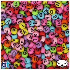 lots of colorful beads with numbers and letters on them, all in the same color