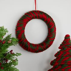 two christmas wreaths are hanging on the wall