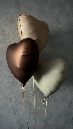 two heart shaped balloons in the shape of hearts