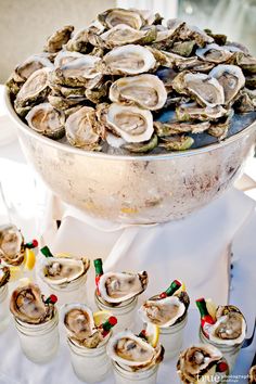 a large platter filled with oysters on top of a table