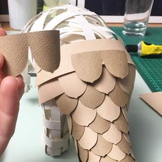 someone is making an origami horse out of paper and glues it on