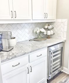 a kitchen with white cabinets and marble counter tops is featured in the magazine butter'n pantry