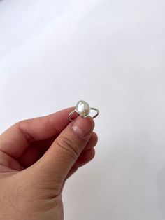 Custom-made Keshi Pearl ring.  Handcrafted Keshi Pearl Ring, all rings are made from scratch. Measuring, hammering, soldering, stone setting and polishing are all done by myself. Please allow up to a week for me to complete your rings, I'll get your ring shipped as soon as I have finished making it 😊 All materials are ethically sourced, ethically sourced pearl and 100% recycled silver. Please note that all pearls come in different shapes and sizes as they're natural freshwater pearl, so your ring might not look exactly like the picture but I can be sure that all pearl is approximately 8~10x7.5x7.5mm. The width of the silver band ring is 1.5mm. the ring is light and comfortable making it perfect for daily wear. Pearl is the birthstone of June babies, this ring is unique and specially handm Handmade White Oval Pearl Ring, Silver Pearl Ring With Round Cut Gemstone, Timeless Silver Pearl Ring With Polished Finish, Keshi Pearl Ring, Silver Pearl Ring With Polished Finish, June Birthstone Ring, Freshwater Pearl Ring, Bezel Ring, Keshi Pearls