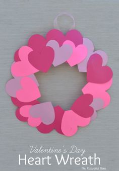 a valentine's day heart wreath made out of pink and purple paper on a gray background