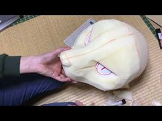 a person is making a mask out of paper