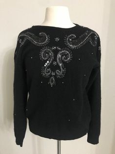 "Beautiful beaded sweater made of lambswool and Angora. This sweater is very gentle on the skin and warm. Very elegant with stones and sequins, perfect to wear during the holidays or as a gift. In great condition like new! Measurements: armpit to armpit: 45\" lenght: 24\" sleeves: 20\" Genesis Vintage Shop accept returns and Exchanges! Joy and satisfaction with your item are very important to us. We want our transactions to go as smoothly and effortlessly as possible and quite simply we want you Elegant Sequined Sweater For Fall, Embellished Crew Neck Sweater For Fall, Winter Sequin Sweater, Black Long Sleeve Sequin Sweater, Black Long Sleeve Sweater With Sequins, Elegant Embroidered Winter Sweater, Embellished Evening Sweater For Winter, Black Winter Sweater With Sequins, Dressy Sweaters