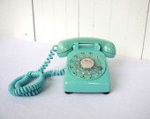 an old - fashioned phone is sitting on a white surface