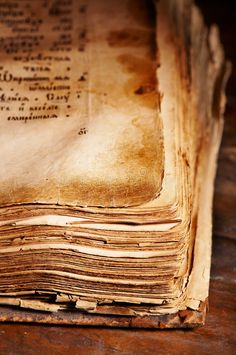 an old book sitting on top of a wooden table