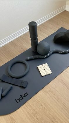 there is a yoga mat with various items on it in the middle of the floor