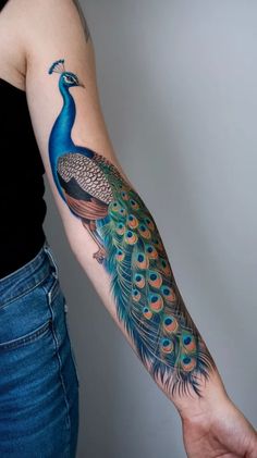 a woman with a peacock tattoo on her arm