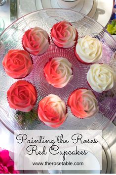 some cupcakes that are sitting on a glass platter with red and white frosting