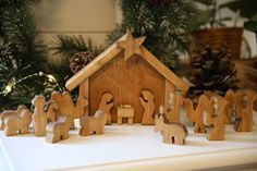 a nativity scene with wooden figurines in the foreground