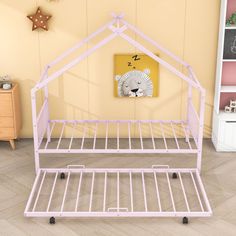 a pink metal bed frame in a child's room