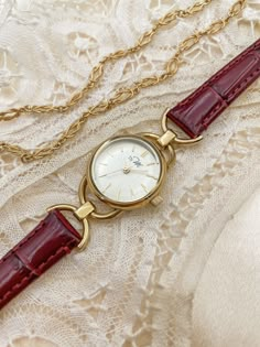 This vintage design watch features gold links and a minimalist circular dial, and a burgundy strap. The cut glass and petite watch face also make it appear like a piece of jewelry. The design behind the LINK collection is inspired by the 1980s. If you love versatile watches, this one provides a classic look that is fitting for all settings, including special occasions. The wrist strap features a crocodile texture and has a luxurious feel to it, which instantly accentuates your feminine sense of style. - DETAILS - SKU: WL005BD Case color: Silver Case size: 23mm Case thickness (including glass): 8mm Dial color: Silver Strap width: 12mm Adjustable length: 140mm-185mm (Min-Max) Strap material: Leather Strap color: Burgundy Quick-release strap for easy installation and removal Movement: Japanes Leather Watches Women, Classic Watches Women Vintage, Petite Watches Women, Feminine Watches Classy, Vintage Leather Watch, Burgundy Jewelry, Feminine Watches, Vintage Pieces, Leather Strap Watch