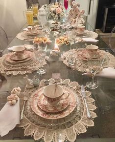 the table is set with dishes, cups and saucers