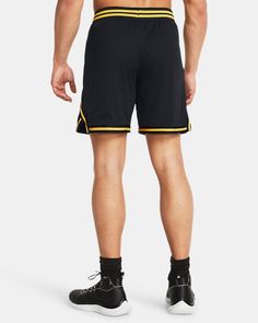 a man wearing black and yellow shorts