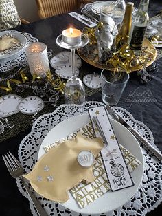 the table is set with silver and gold decorations